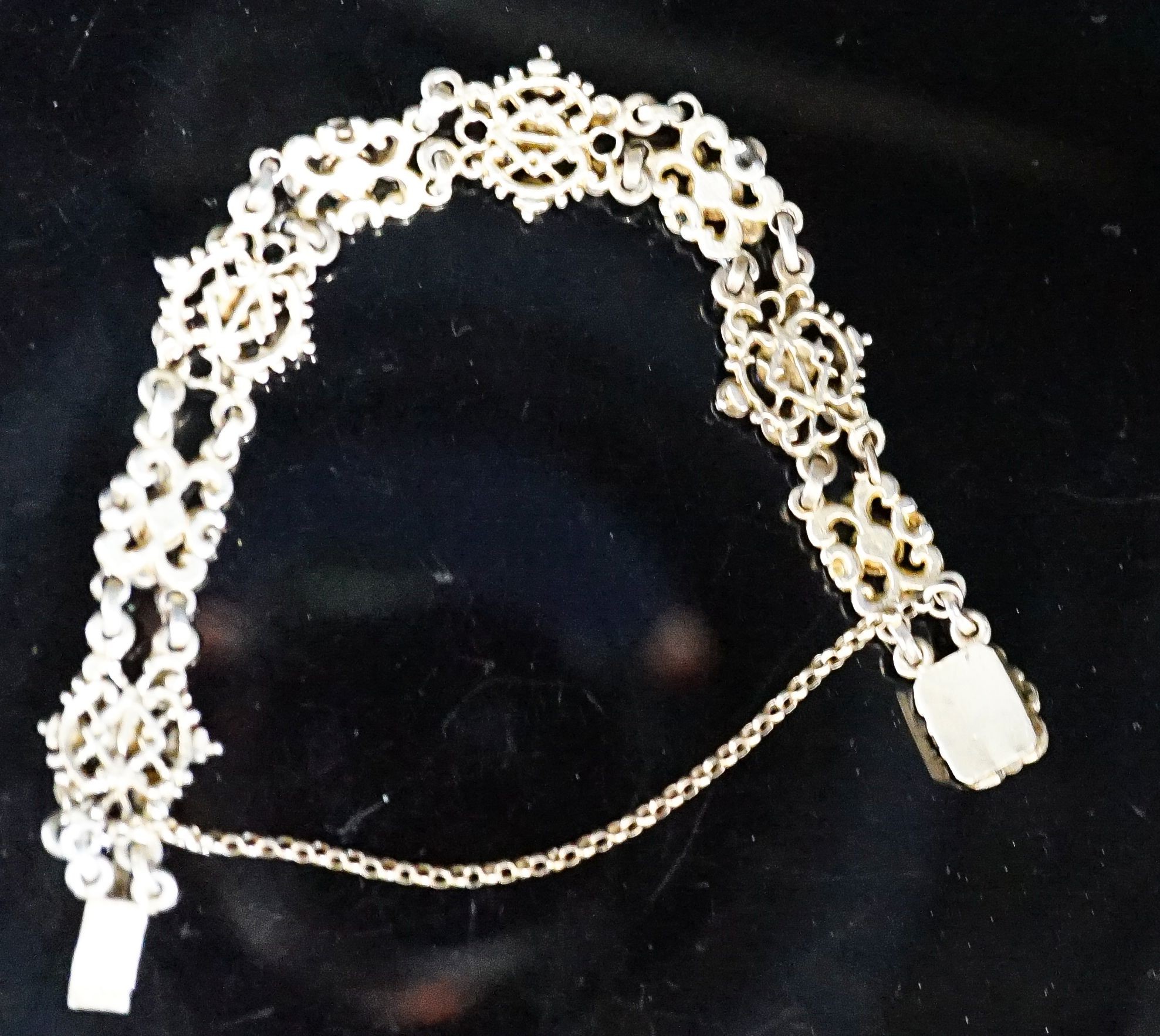 A continental gilt white metal, sapphire and split pearl flower head cluster set bracelet